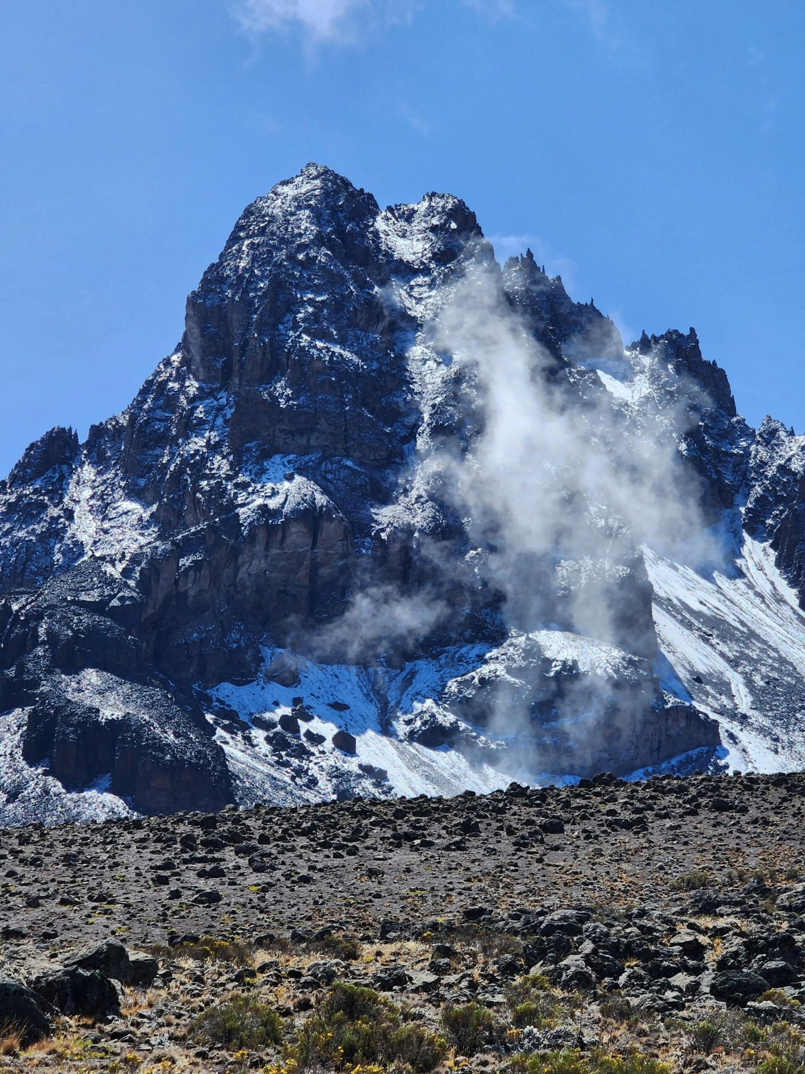 Snow-dusted Mawenzi Peak on Mount Kilimanjaro under a bright sky